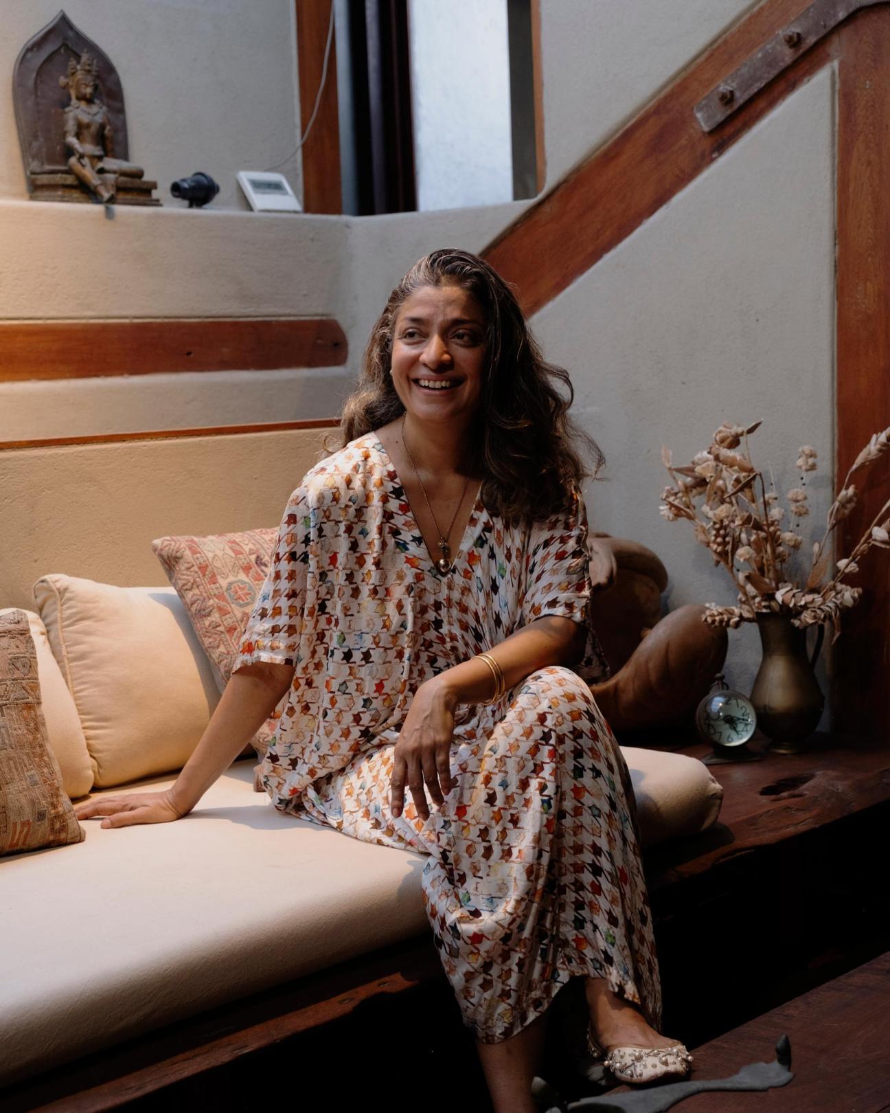 Divya Thakur, sitting on a sofa