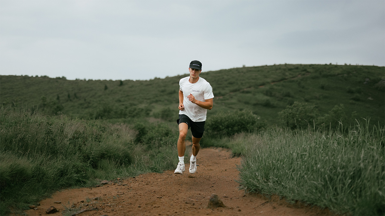 A campaign image for Acid Runner – a man running down a country path.