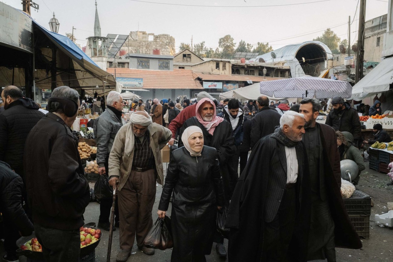 Syria, Damascus, 2025. People walk in an open market in Damascus centre.