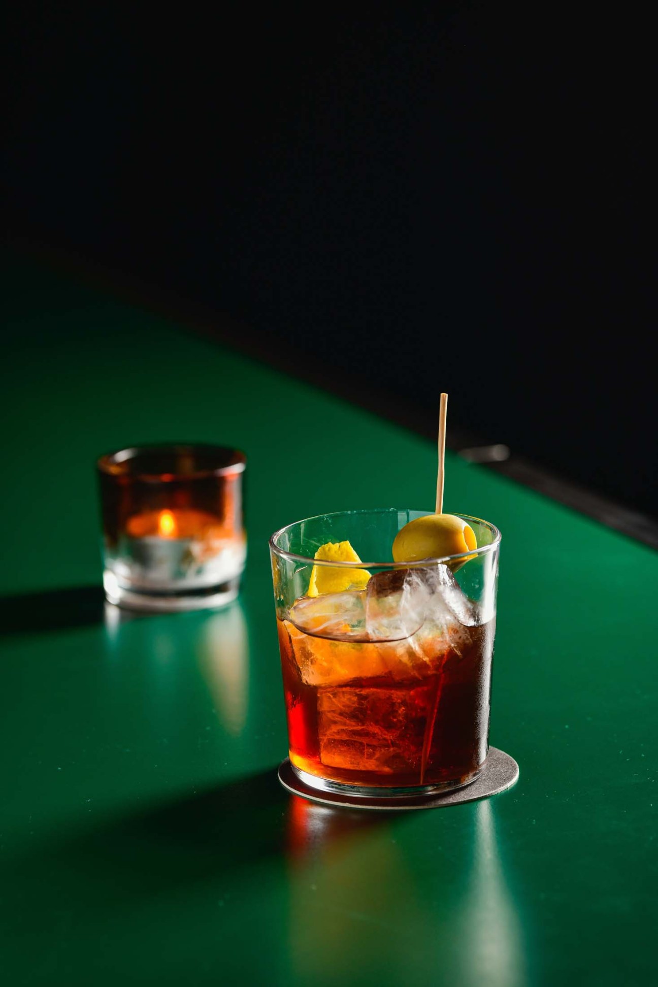A cocktail on a green counter