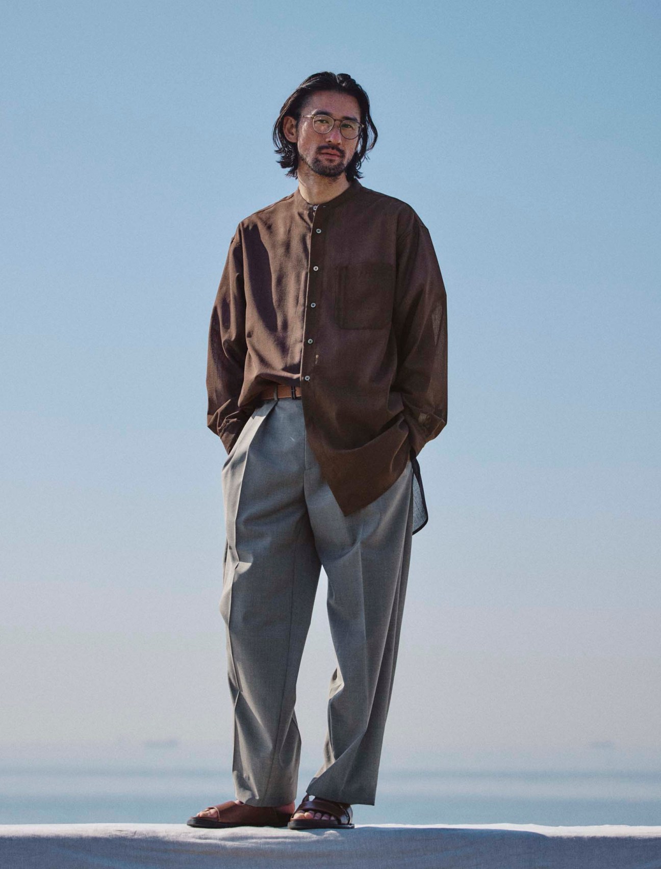 Shirt by Polyploid, trousers by Emporio Armani, sandals by JM Weston, belt by Hermès, glasses by Mykita