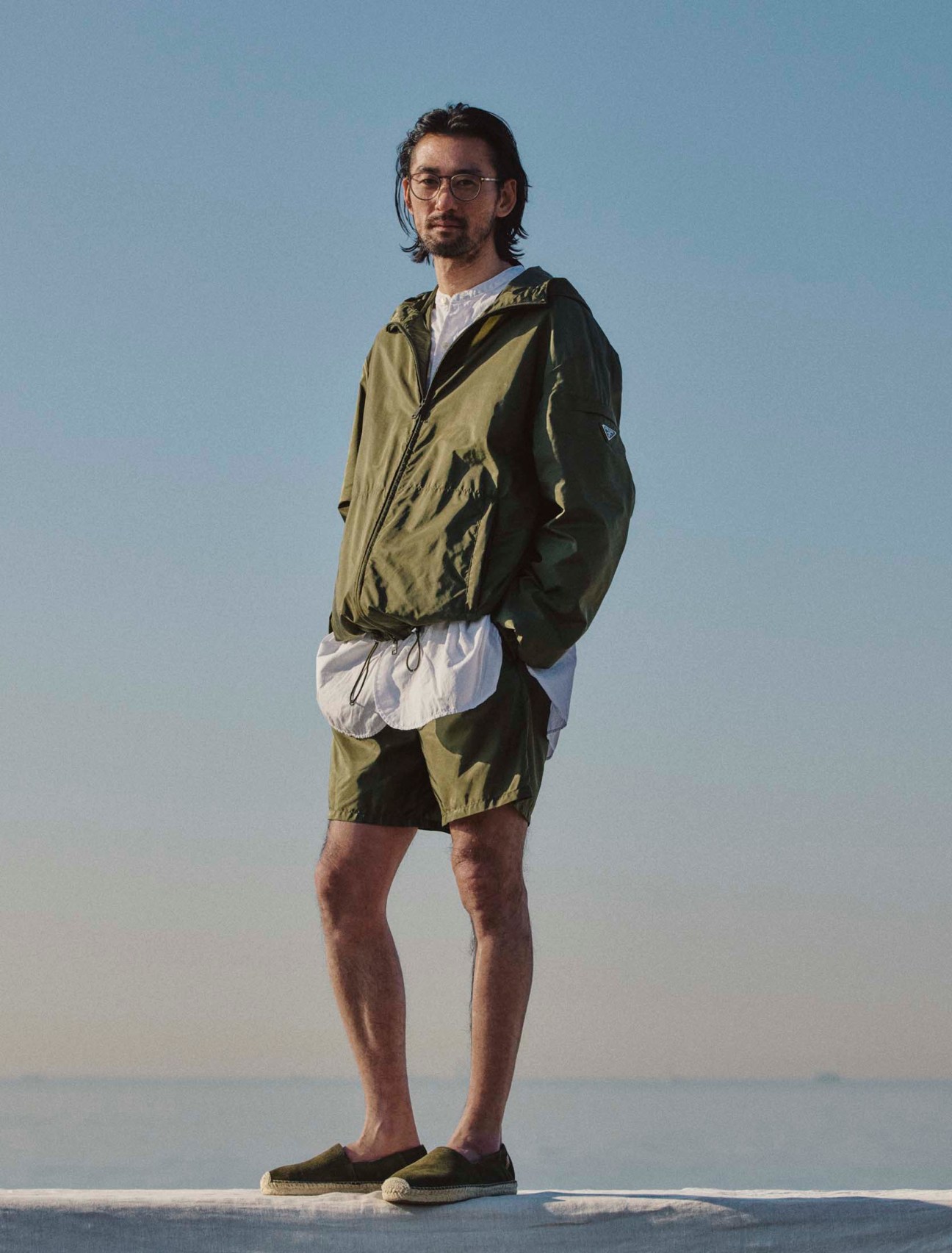 Jacket and shorts by Prada, shirt by Sans Limite, espadrilles by Polo Ralph Lauren, glasses by Mykita