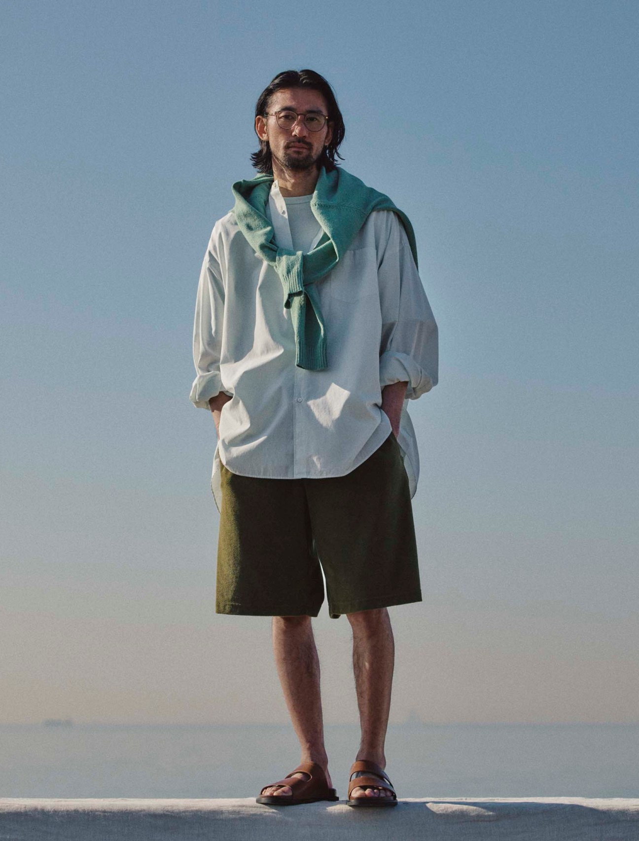 Jumper by Beams Plus, shirt and t-shirt by Graphpaper, shortsby Herno, sandals by JM Weston, glasses by Mykita