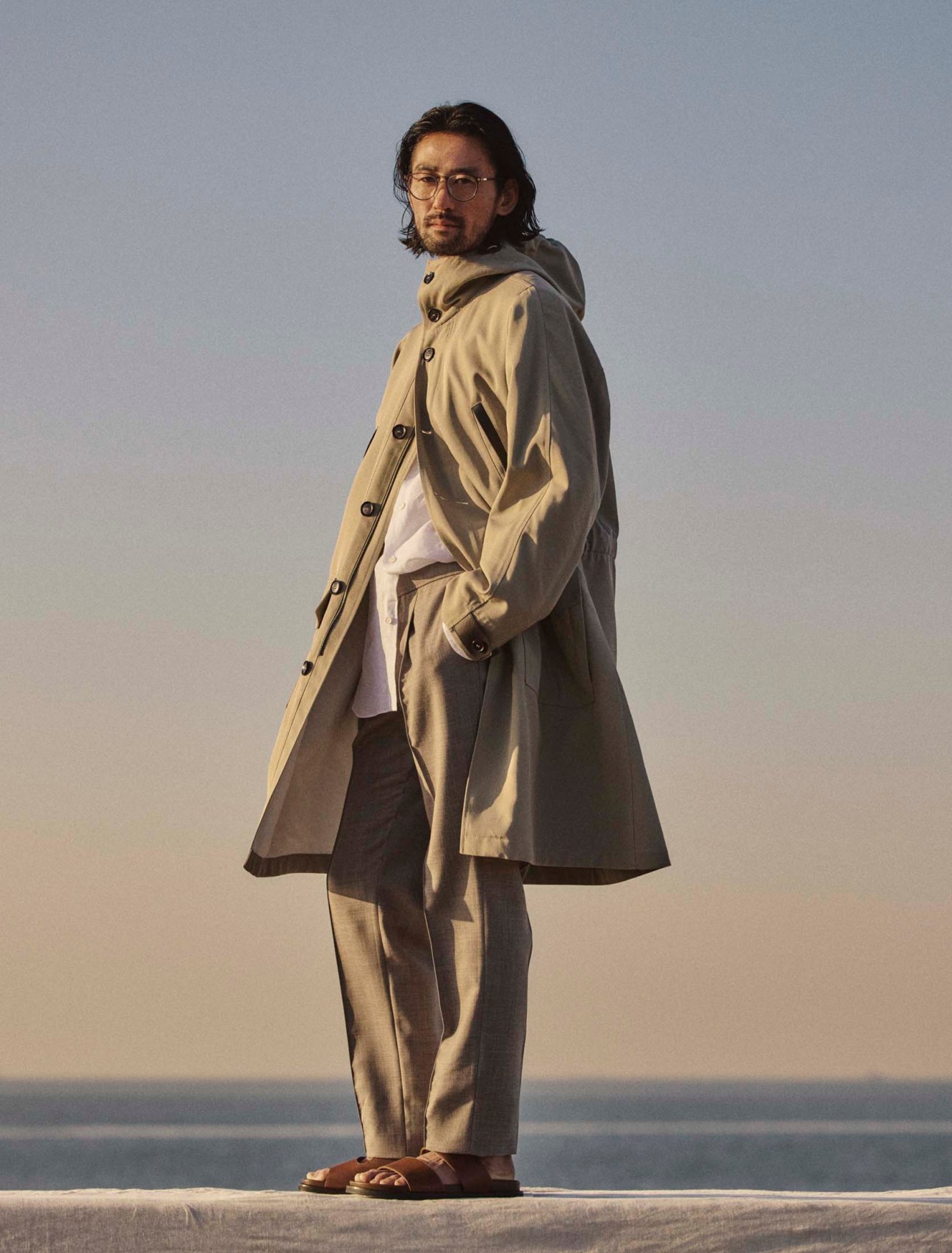 Coat, shirt and trousers by Brioni,sandals by JM Weston, glasses by Mykita