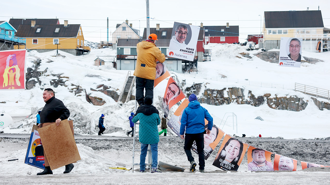 Protesters in Greenland picking up bunting.