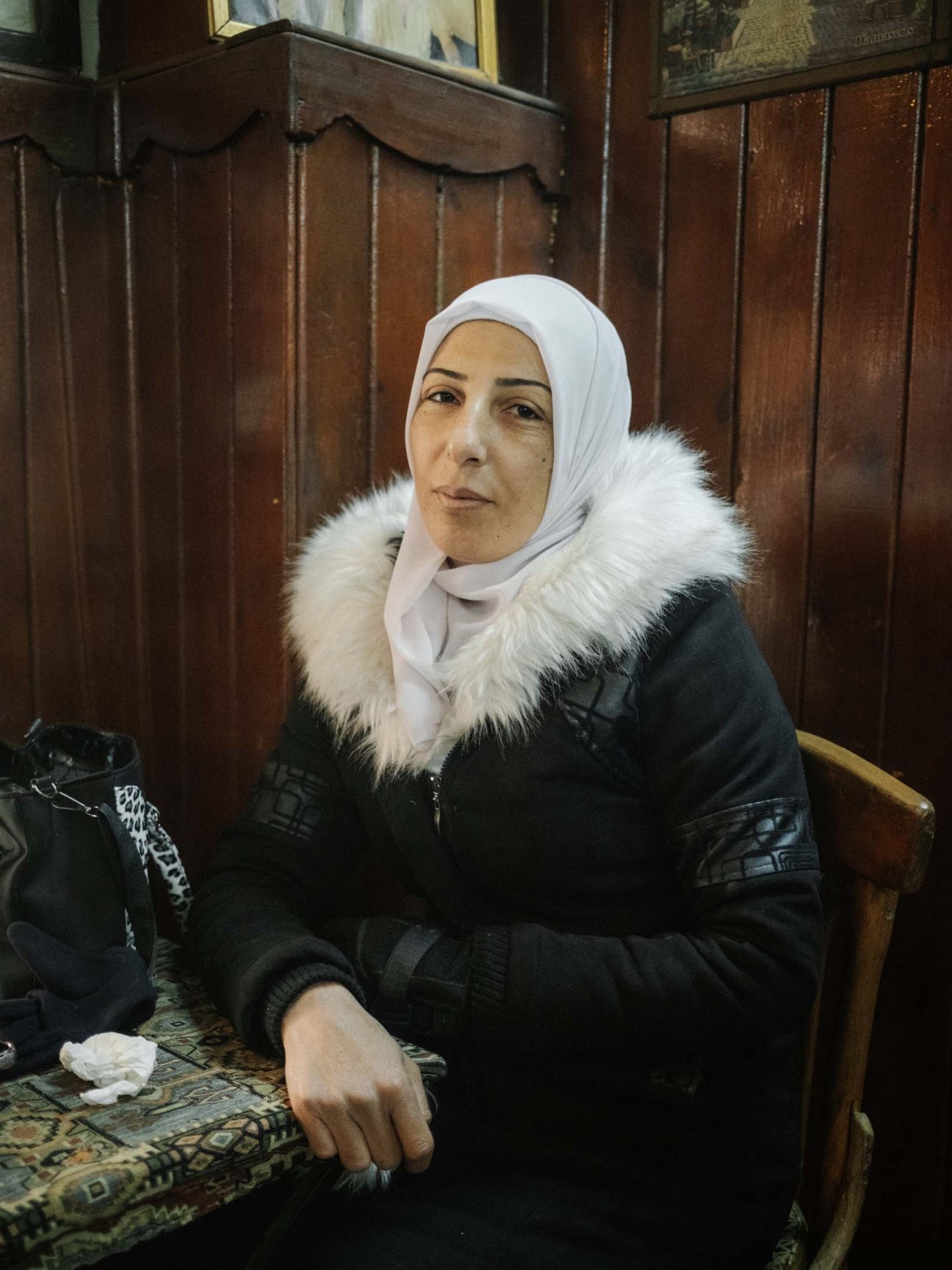Syria, Damascus, 2025. Manal al Sufadi, poses in traditional coffee shop in Damascus old city.