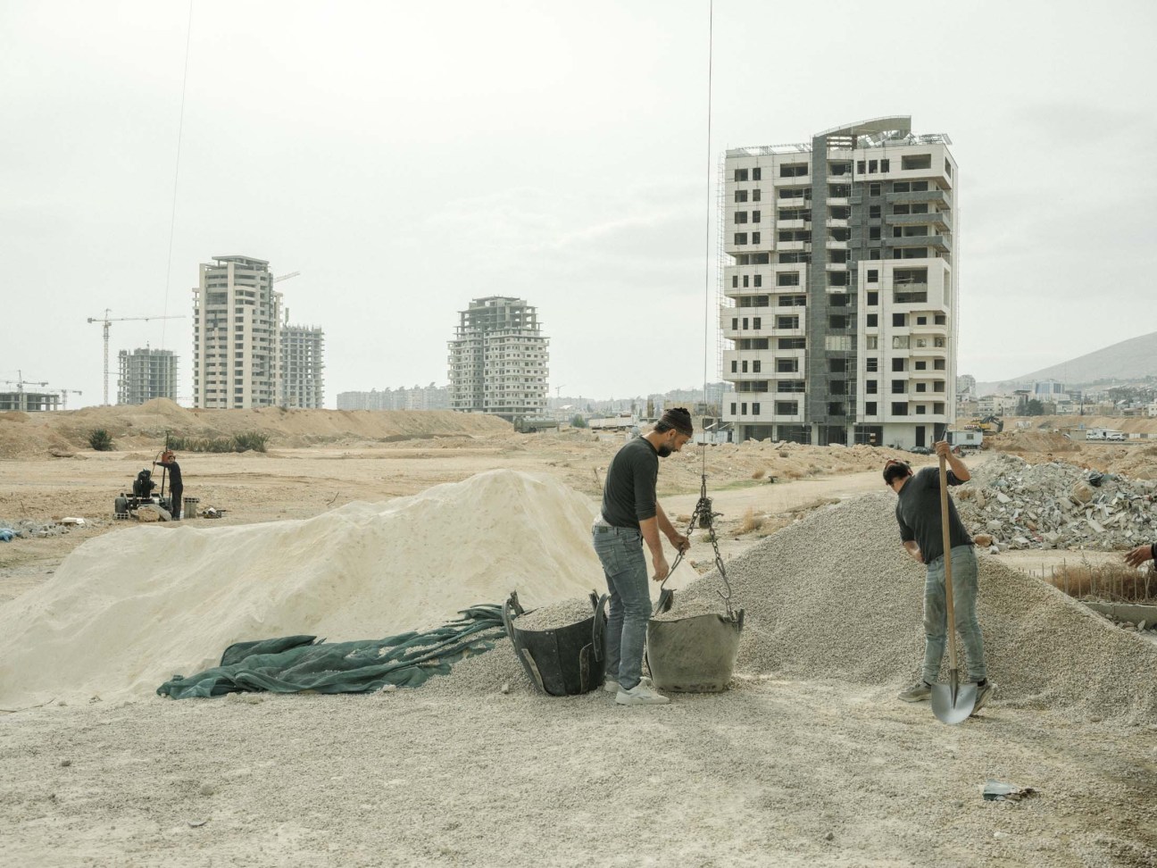Syria, Damascus, 2025. Men work in construction site in Mazzeh district in Damascus.
