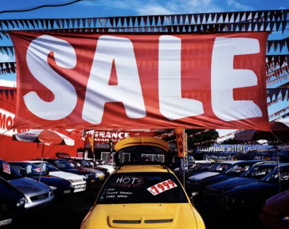 Enormous sale sign on a car showroom floor