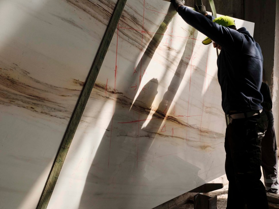 Work taking place on a stone slab in a factory