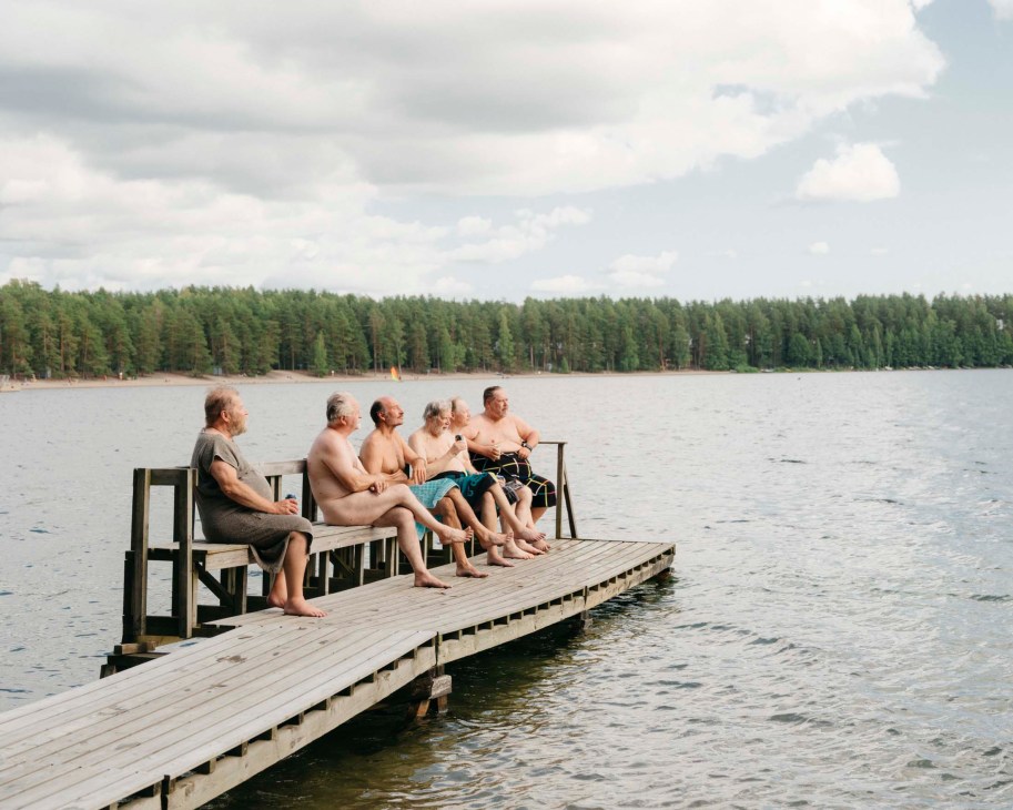 A group of men sat by a lake