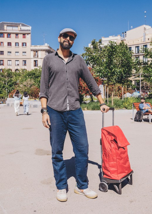 A man with a Rolser shopping trolley