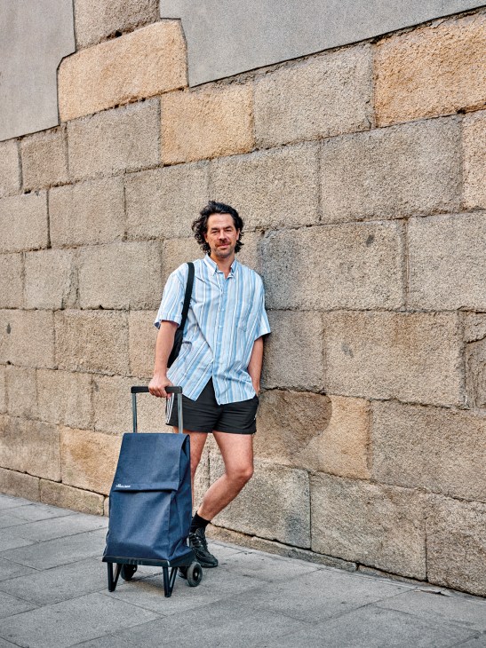 A man with a Rolser shopping trolley