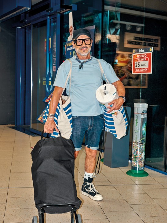 A man with a Rolser shopping trolley