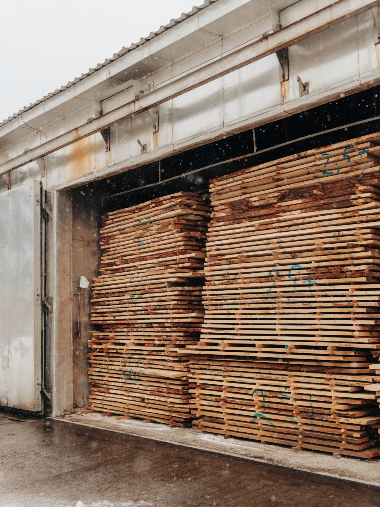 Stacked processed wood in drying chambers