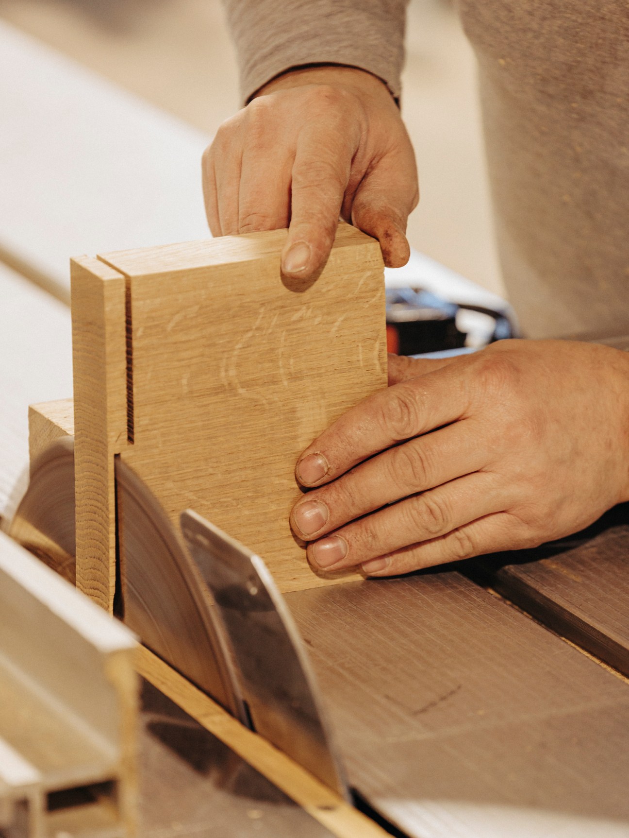 Craftsperson using a table saw with precision at Raw workshop