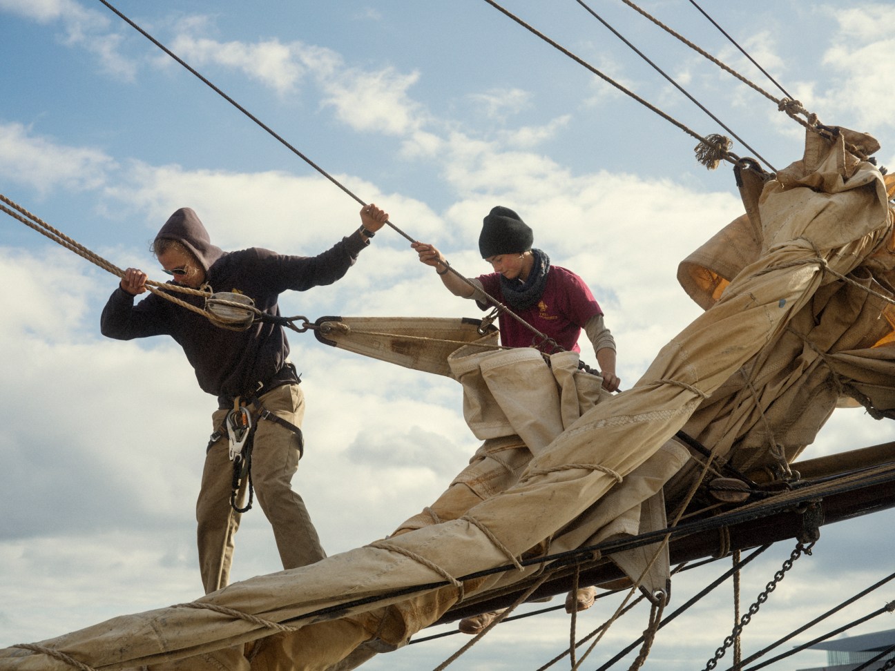 Bosun Eilish Turnbull and deckhand Markus Rapponen furl the headsails