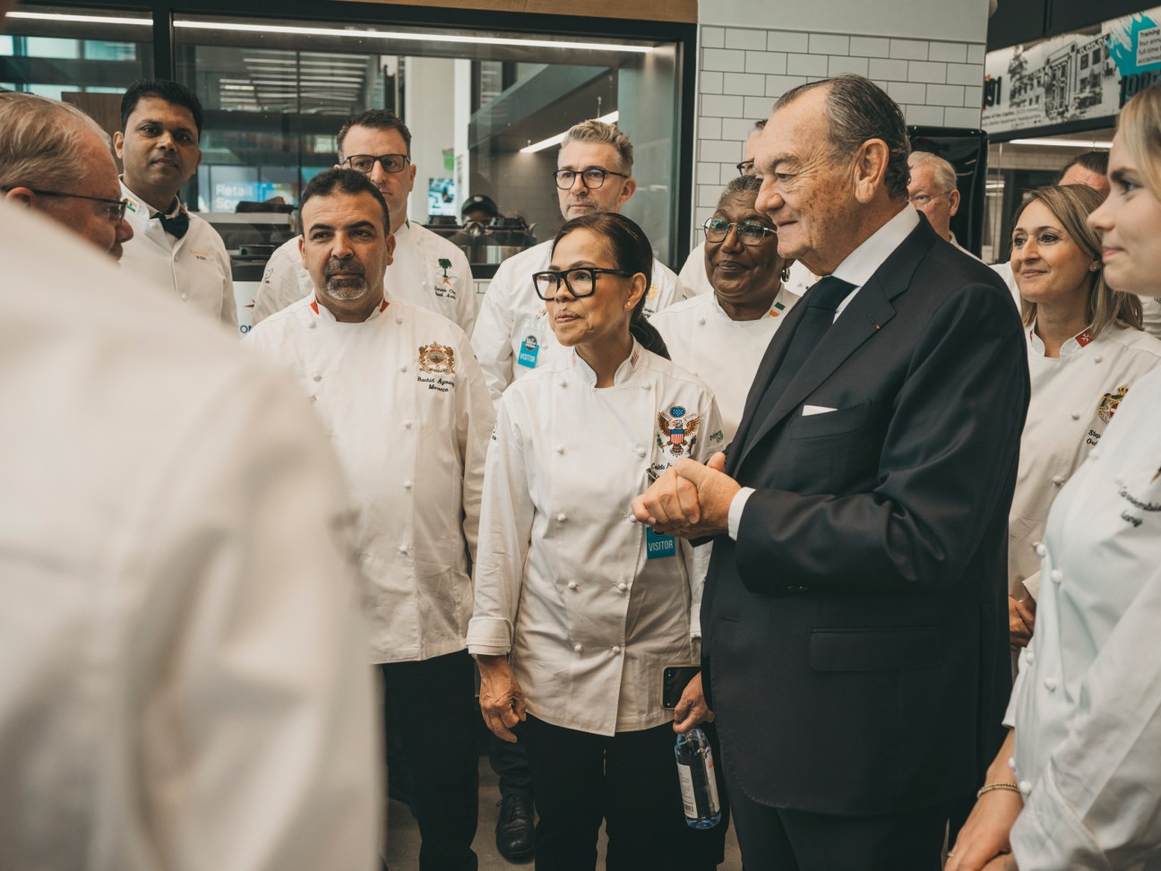 Three chefs in discussion at the Chefs des Chefs event