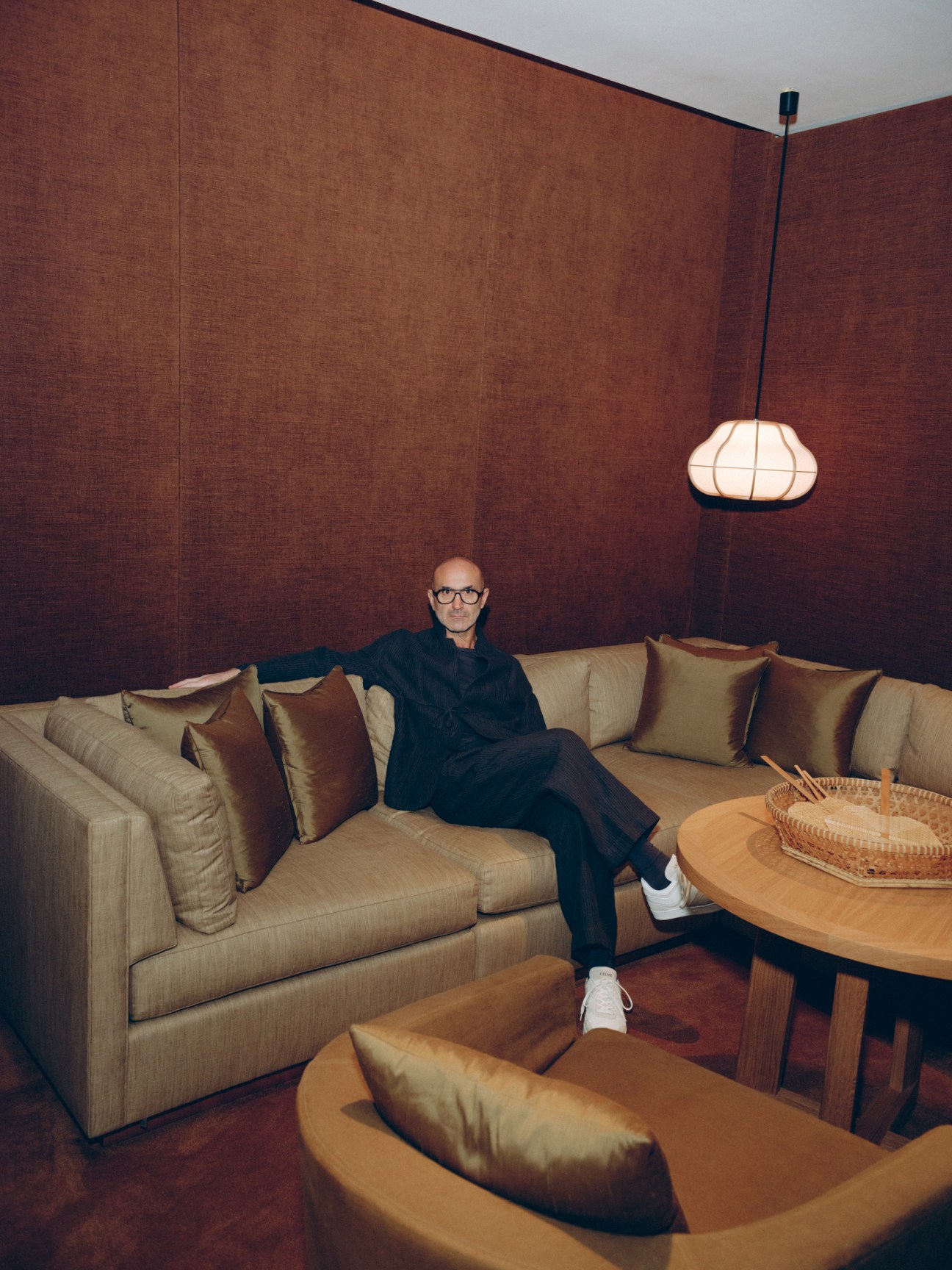 man sitting on a beige angular sofa