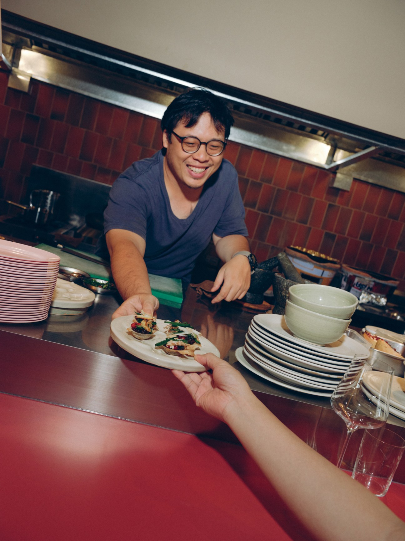 serving food at a Thai restaurant