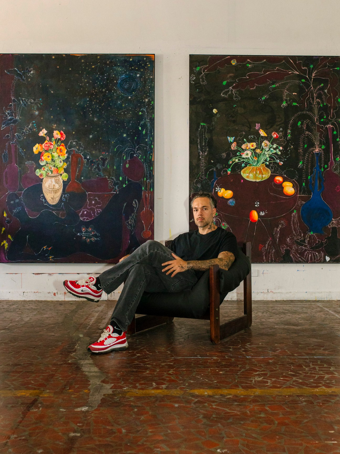 Paulo Nimer Pjota in his studio with his artwork