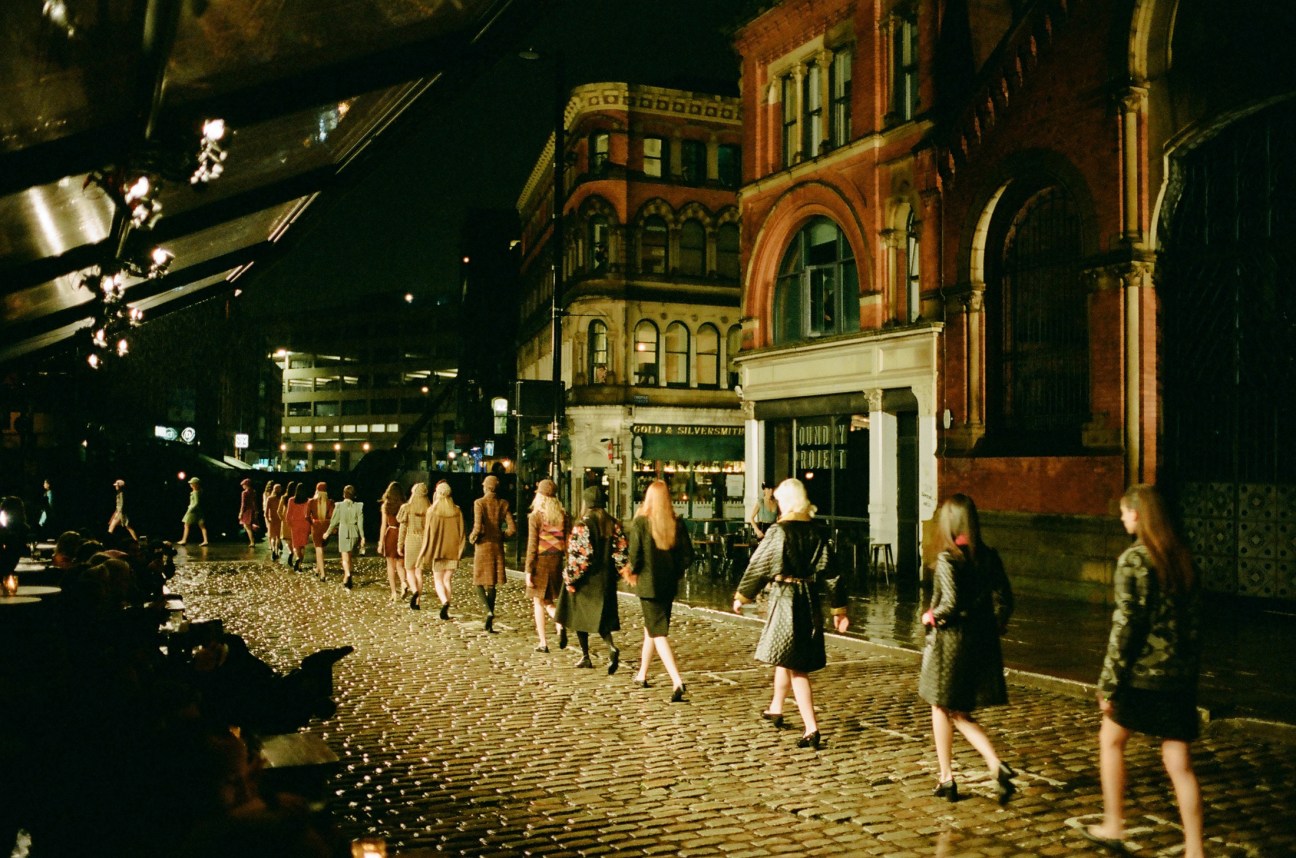 Crowd gathers along the runway in the streets of Manchester