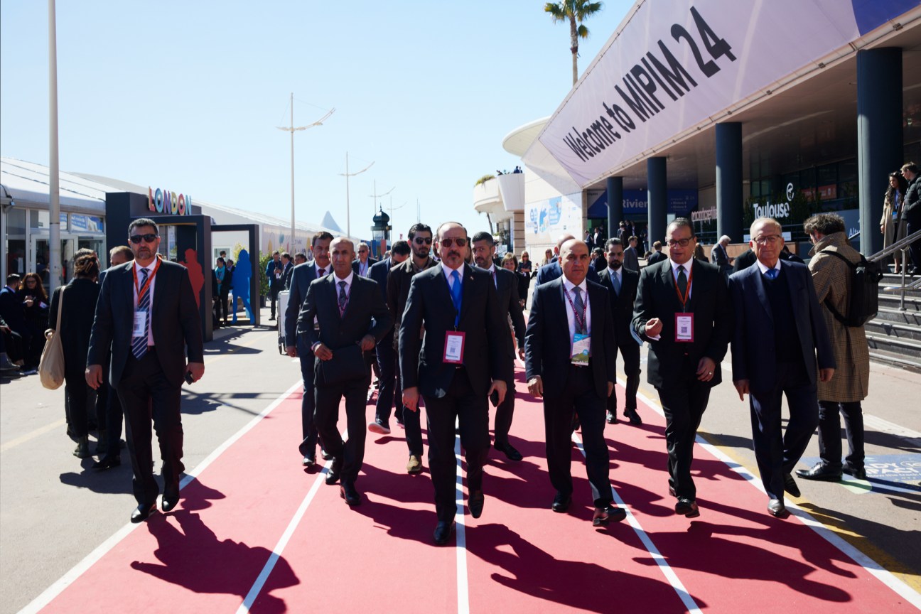 Delegations walking on a running track