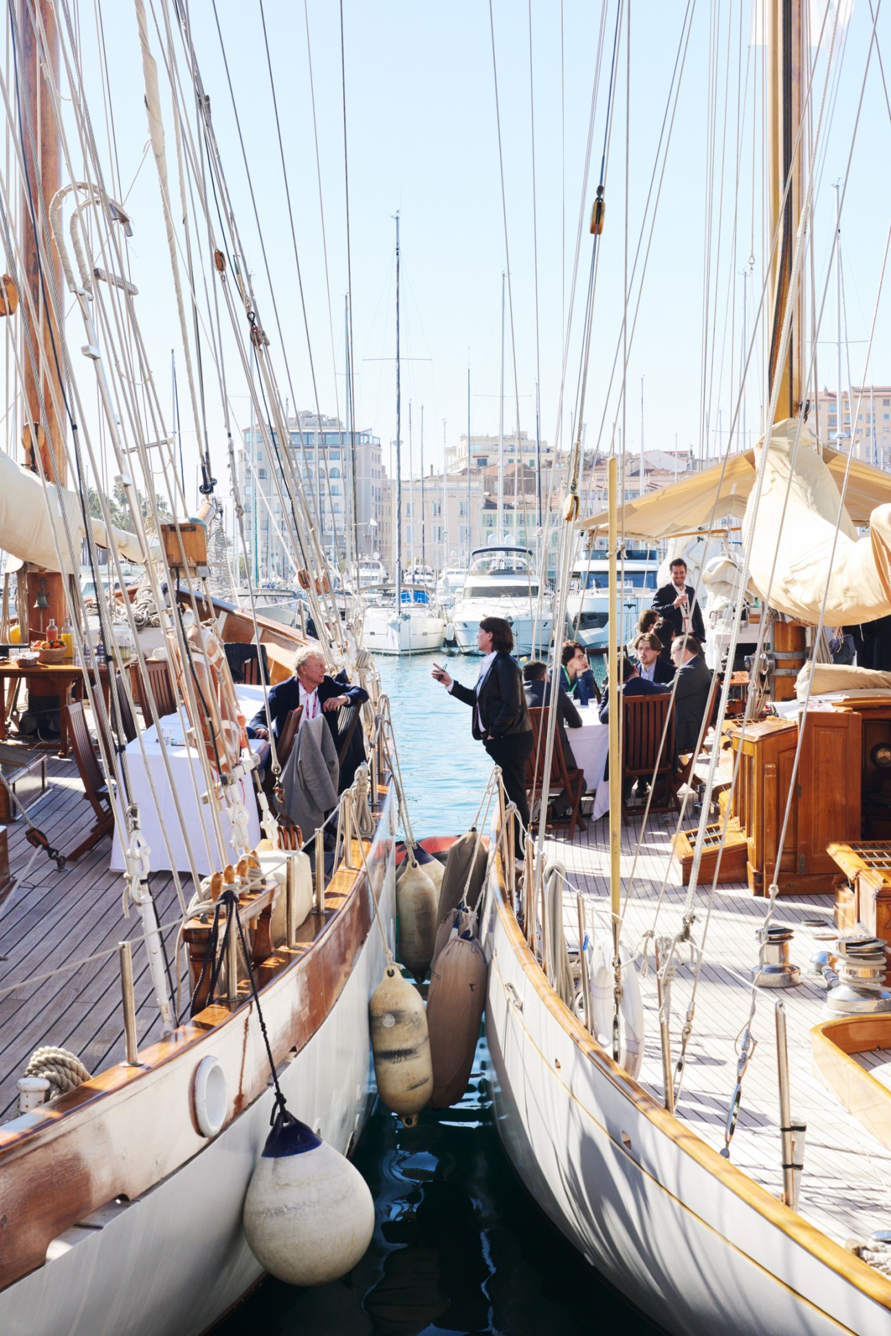 Real estate delegates networking on the deck of a yacht moored in Cannes