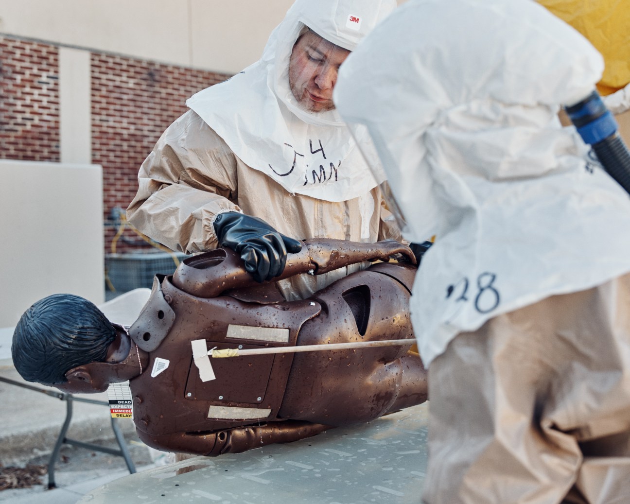 Medical professional tending to a training mannequin