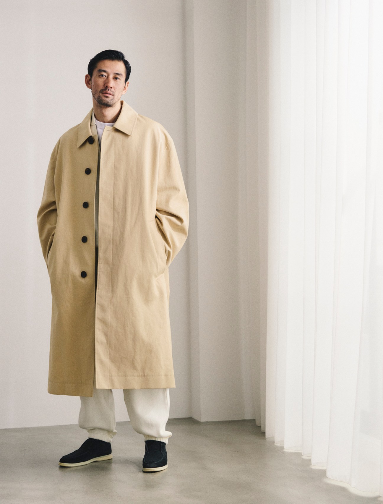 Coat by Studio Nicholson, sweatshirt and sweatpants by Emporio Armani, t-shirt by Cahlumn, shoes by Loro Piana