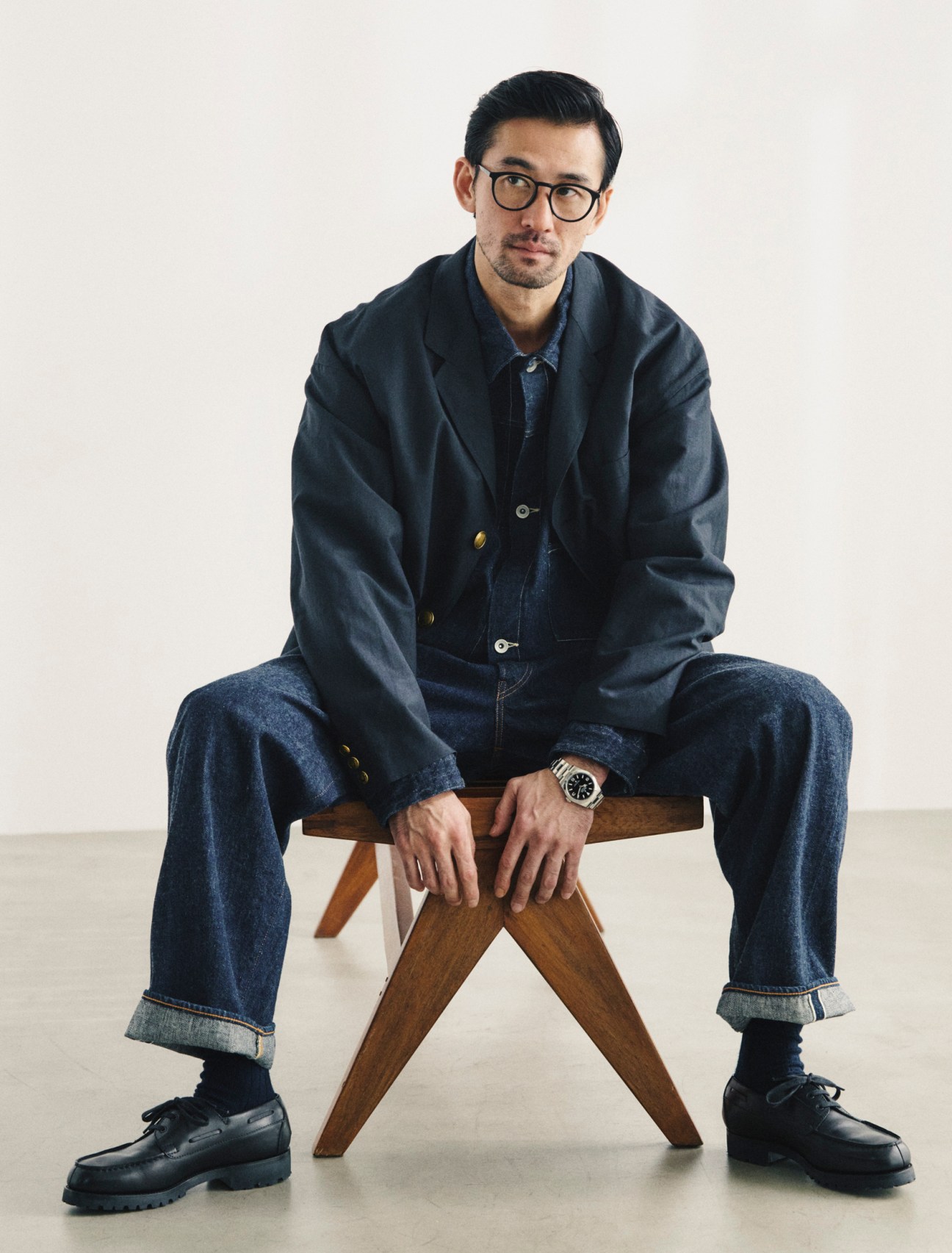 Outer jacket by Visvim, jacket and jeans by Comoli, socks by Tabio, shoes by JM Weston, glasses by Mykita, oyster perpetual explorer 40 watch by Rolex