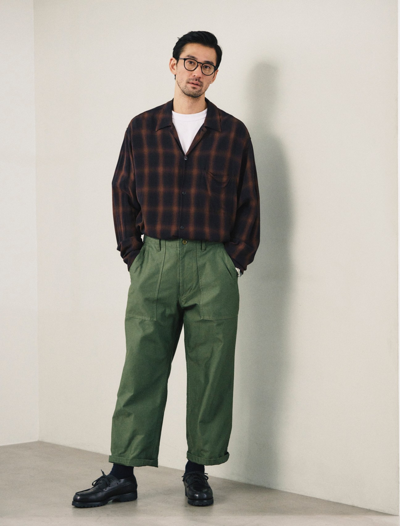 Shirt by Comoli, t-shirt by Cahlumn, trousers by Beams Plus, socks by Tabio, shoes by JM Weston, glasses by Mykita, oyster perpetual explorer 40 watch by Rolex