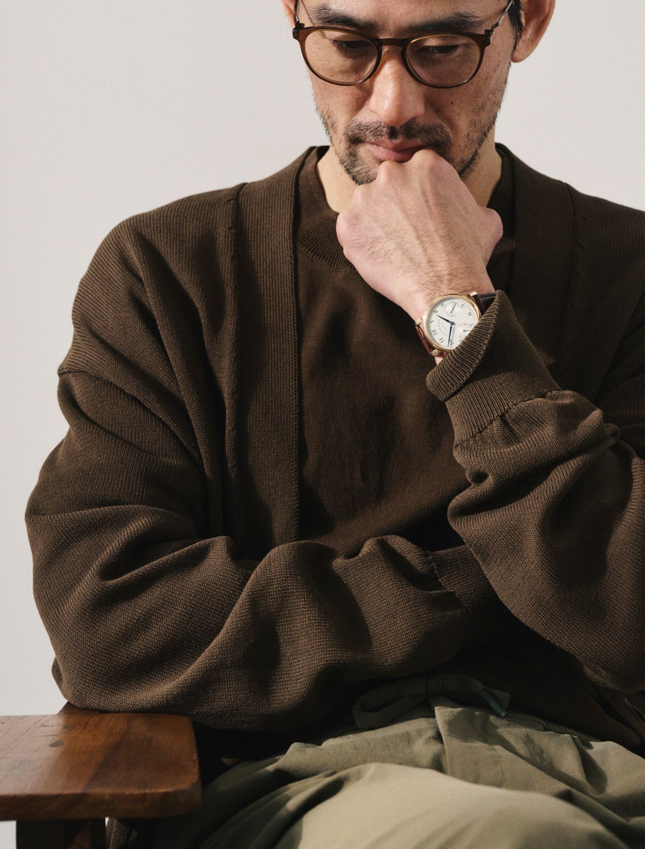 Cardigan and t-shirt by Studio Nicholson, trousers by Colmar, glasses by Mykita, 1815 up/down watch by A Lange & Söhne
