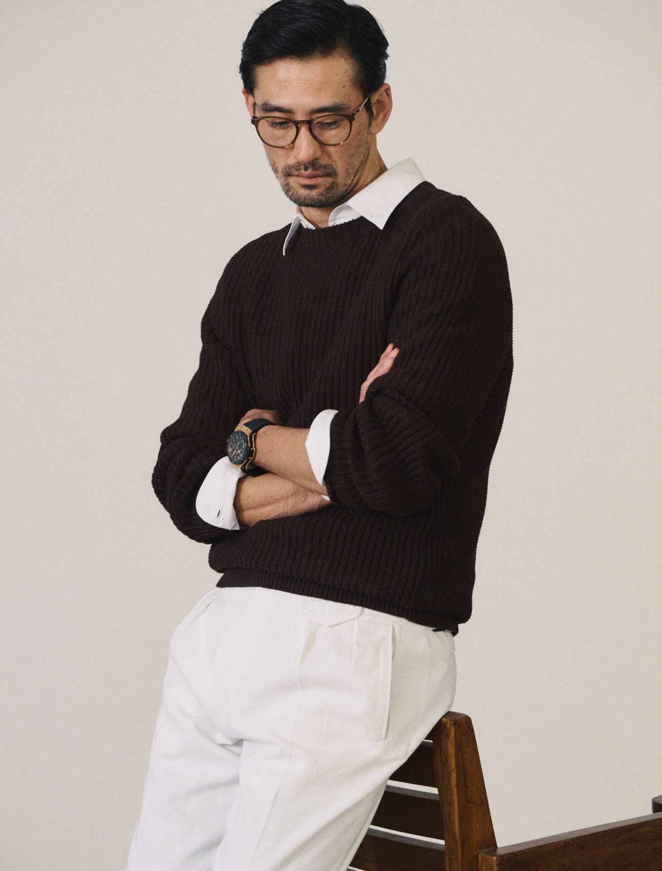 Jumper by Dunhill, shirt by Comoli, trousers by Incotex, glasses by Mykita, big bang gold ceramic watch by Hublot