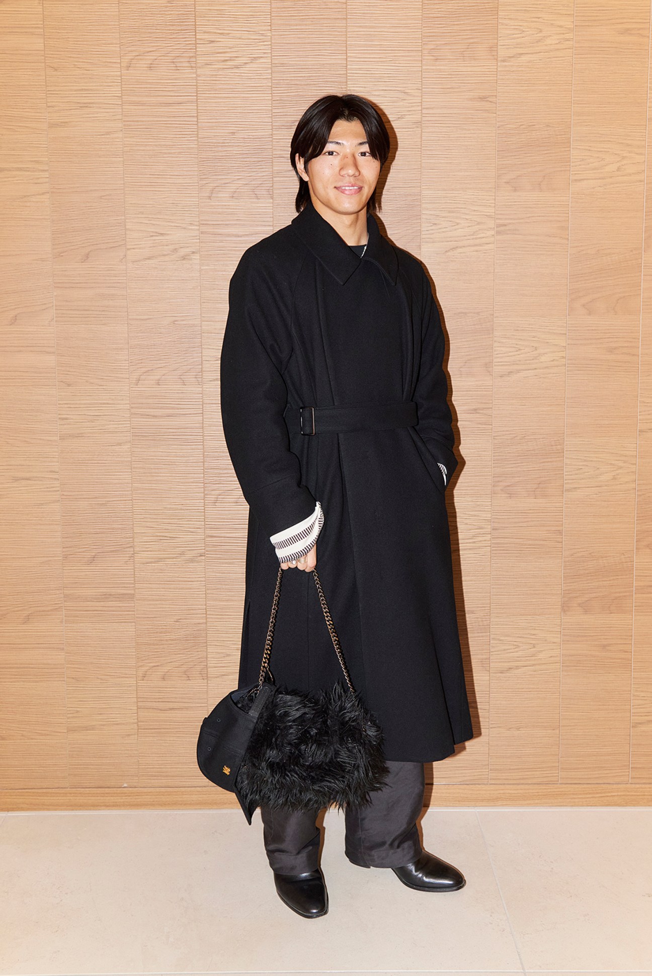 Man in formal attire walking inside a shopping center