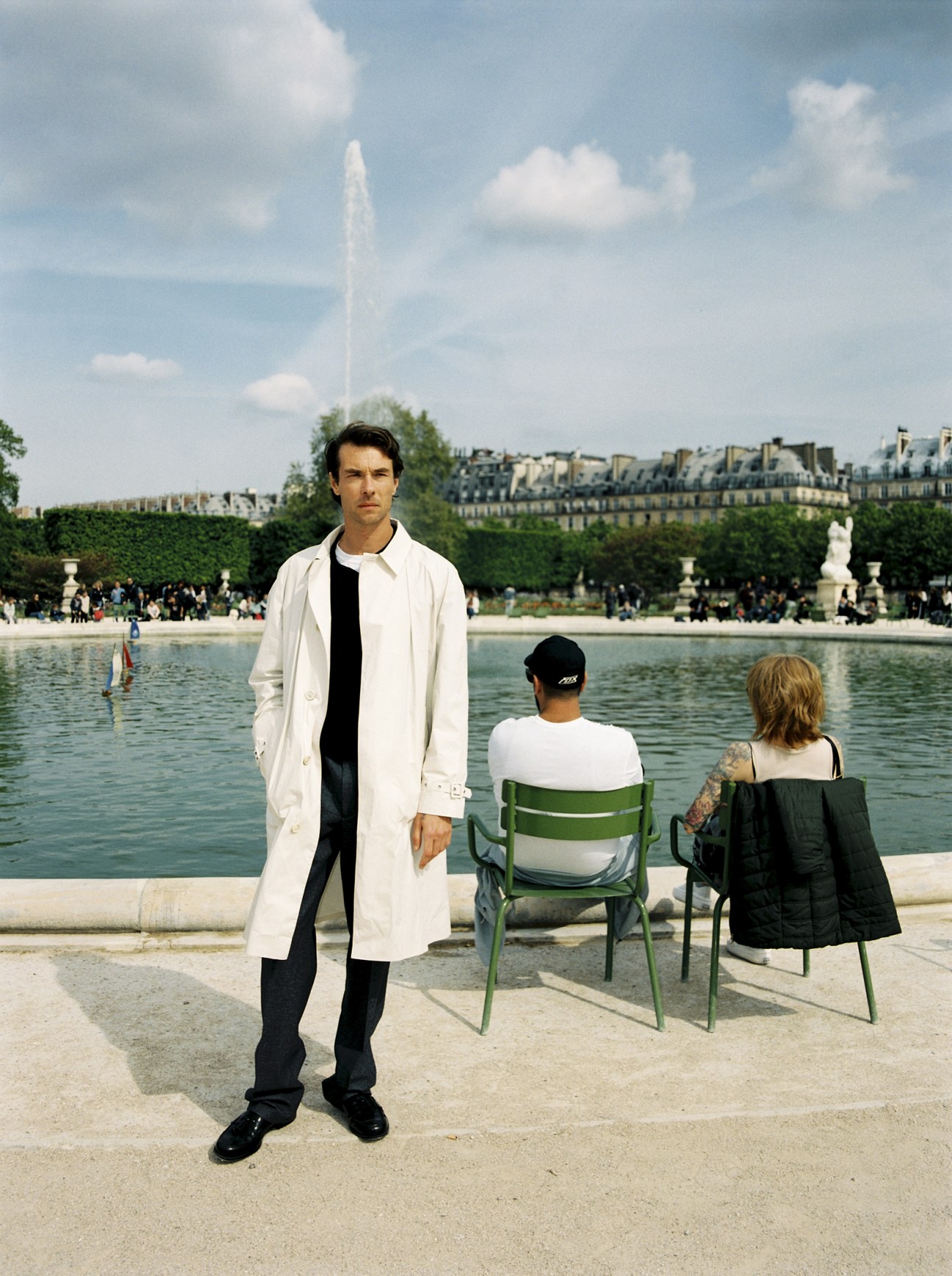 Oscar Coop-Phane wears coat, jumper, trousers and shoes by Prada, polo shirt by Tricot