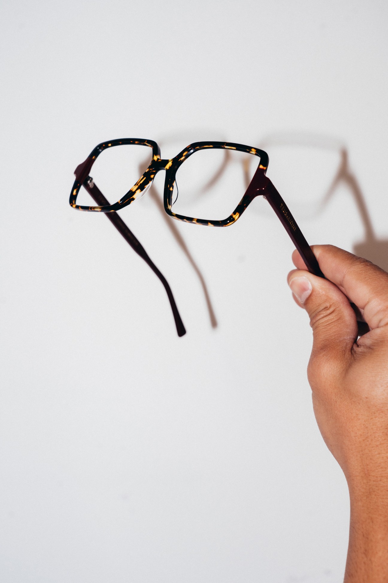Artisan crafting handmade eyewear at Zeus 1 Dione workshop