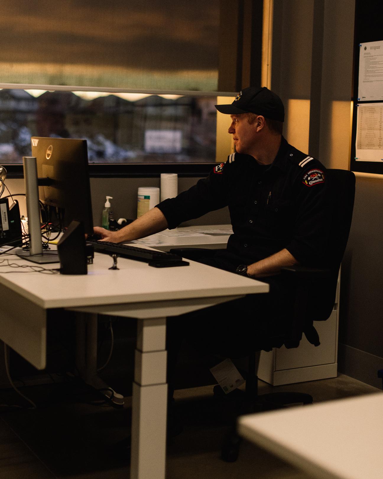 Firefighter sitting at his desk