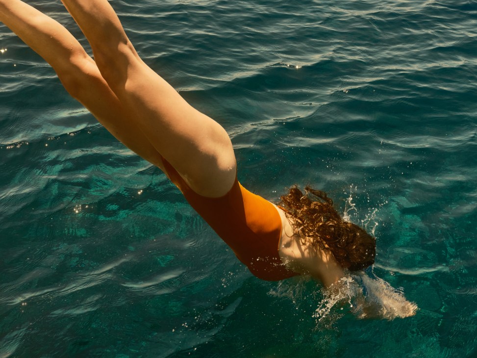 Model wearing Isole & Vulcani sustainable swimwear in a natural setting
