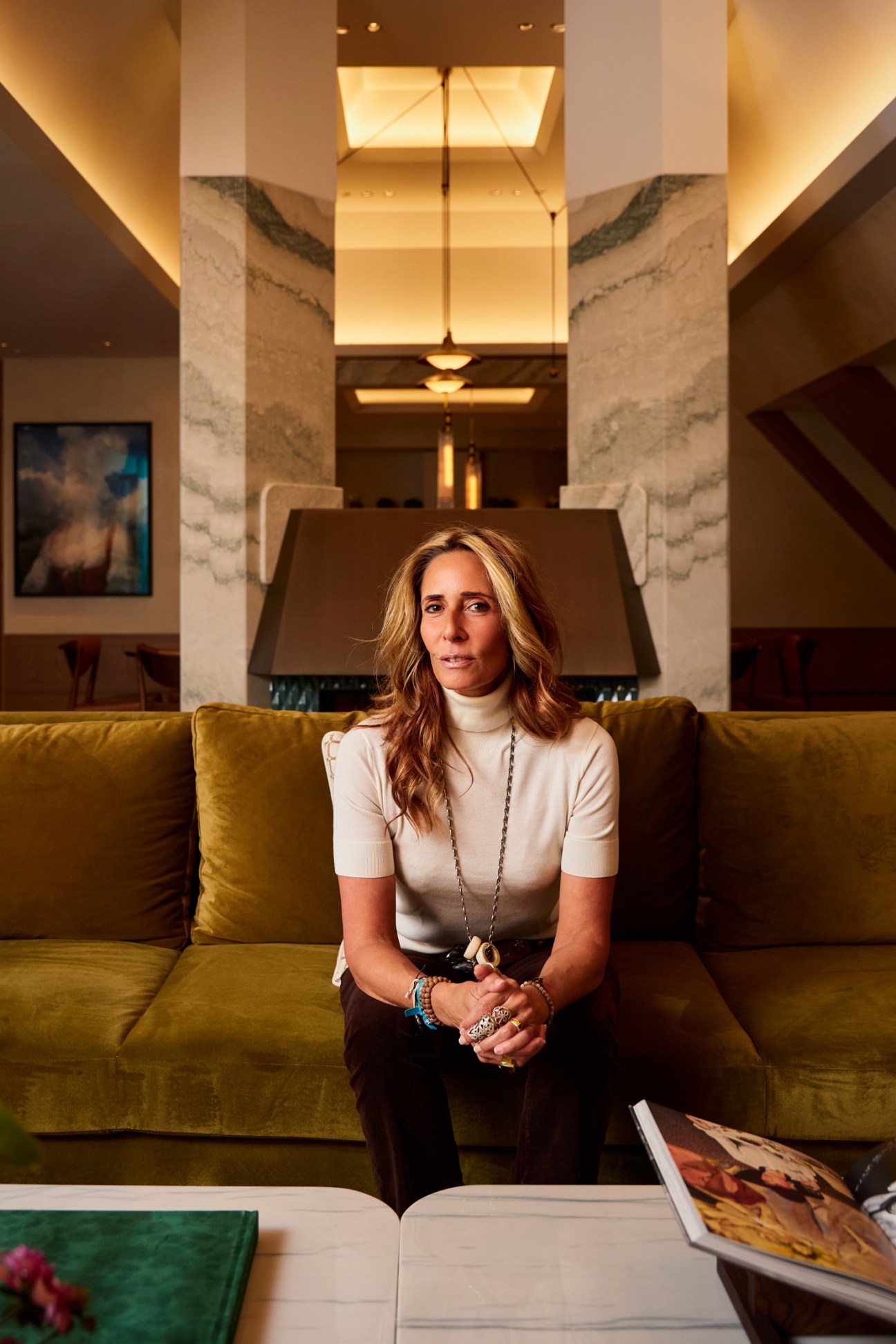 woman sitting on an amber sofa