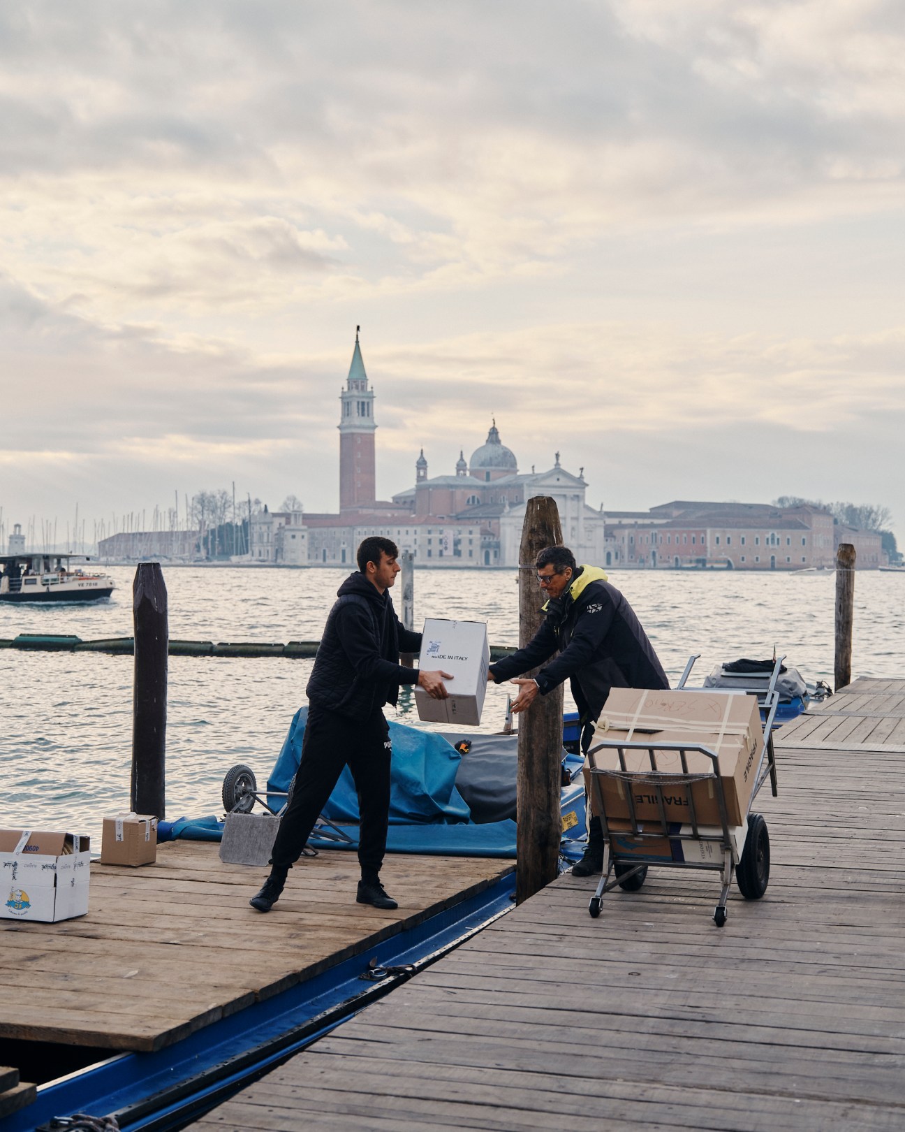 Worker unloading produce at Venice dock