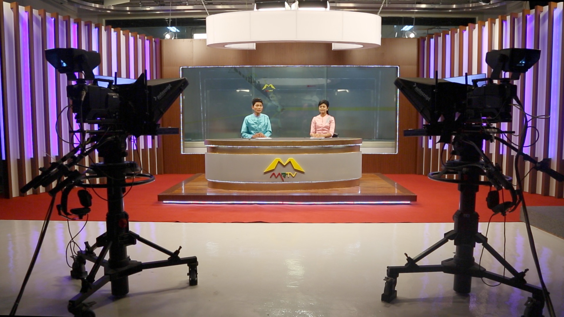 Presenters in a TV studio in Burma.