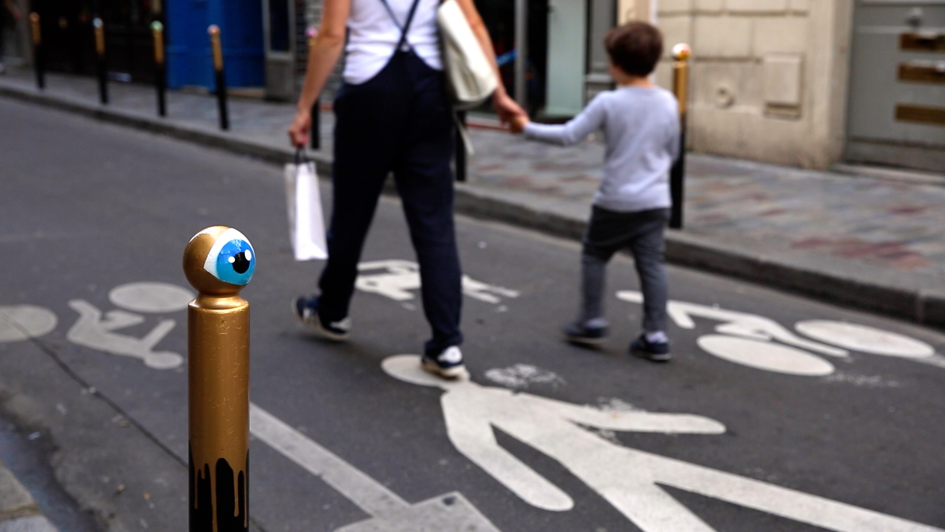 Mother and son walking in a street